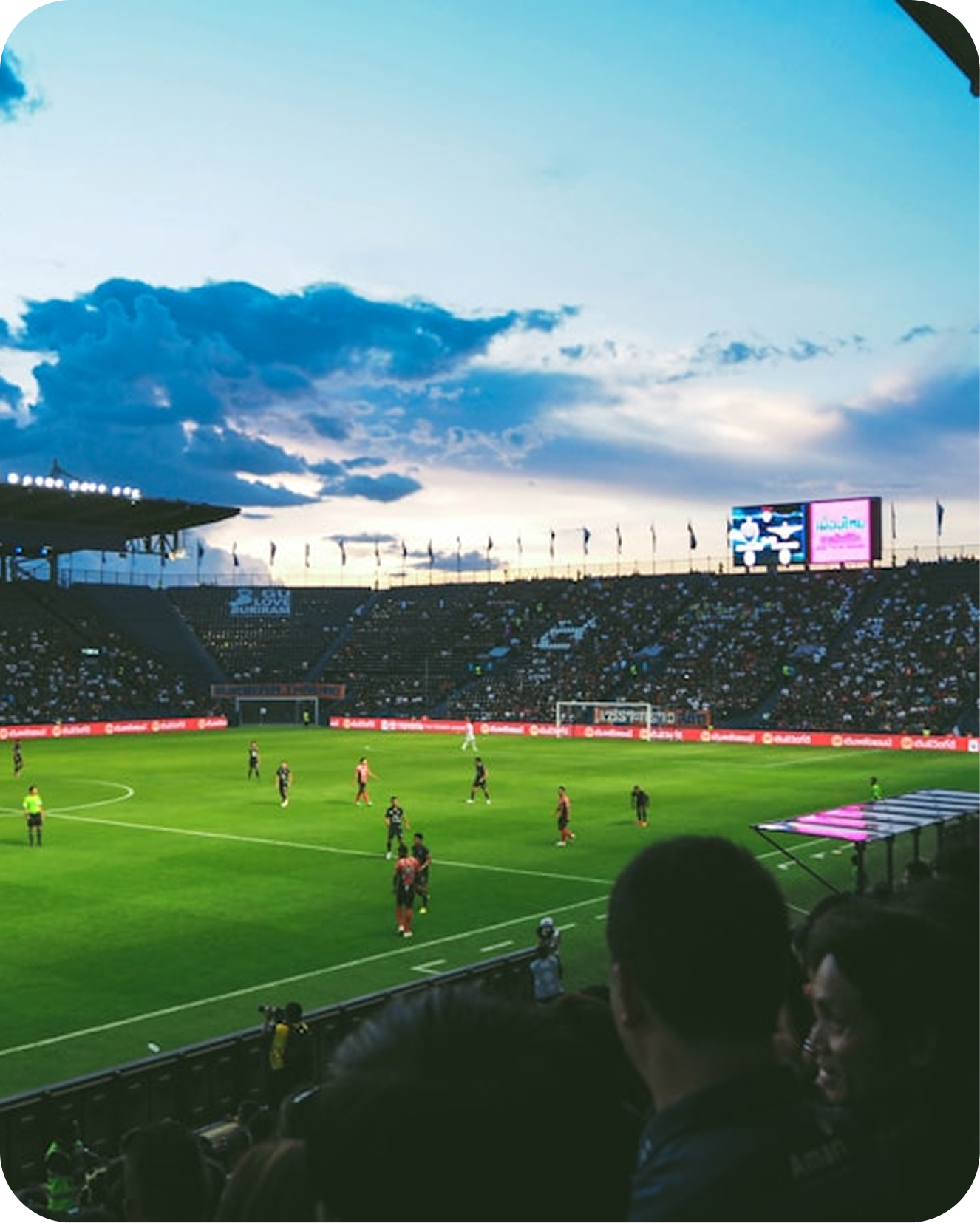 Spectators in a soccer stadium at night