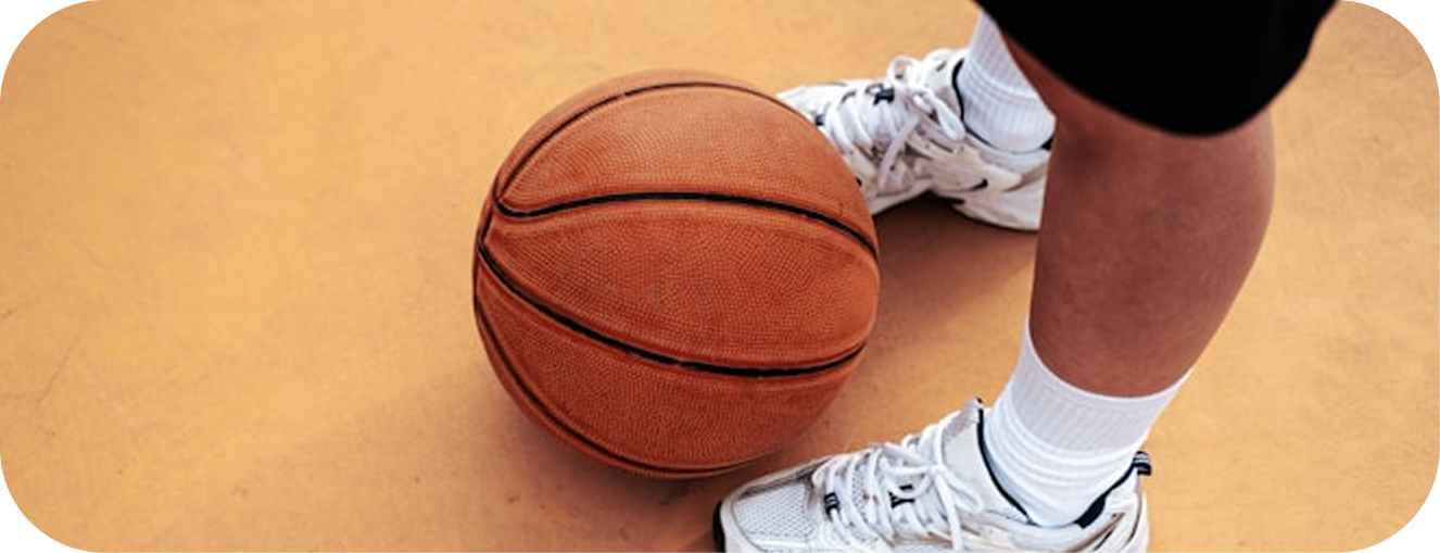 Basketball on court with shoes visible